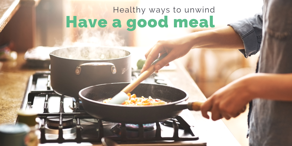 "Healthy ways to unwind: Have a good meal". Someone tending to a pan on a stove while steam rises from a pot. 